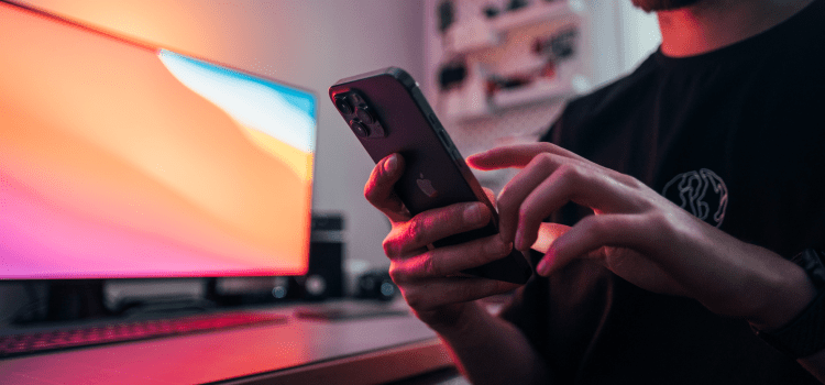 man using mobile phone at desk