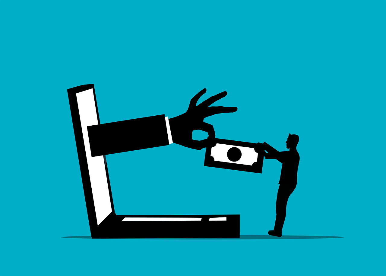 Man standind before laptop and giving money to the hand in the laptop