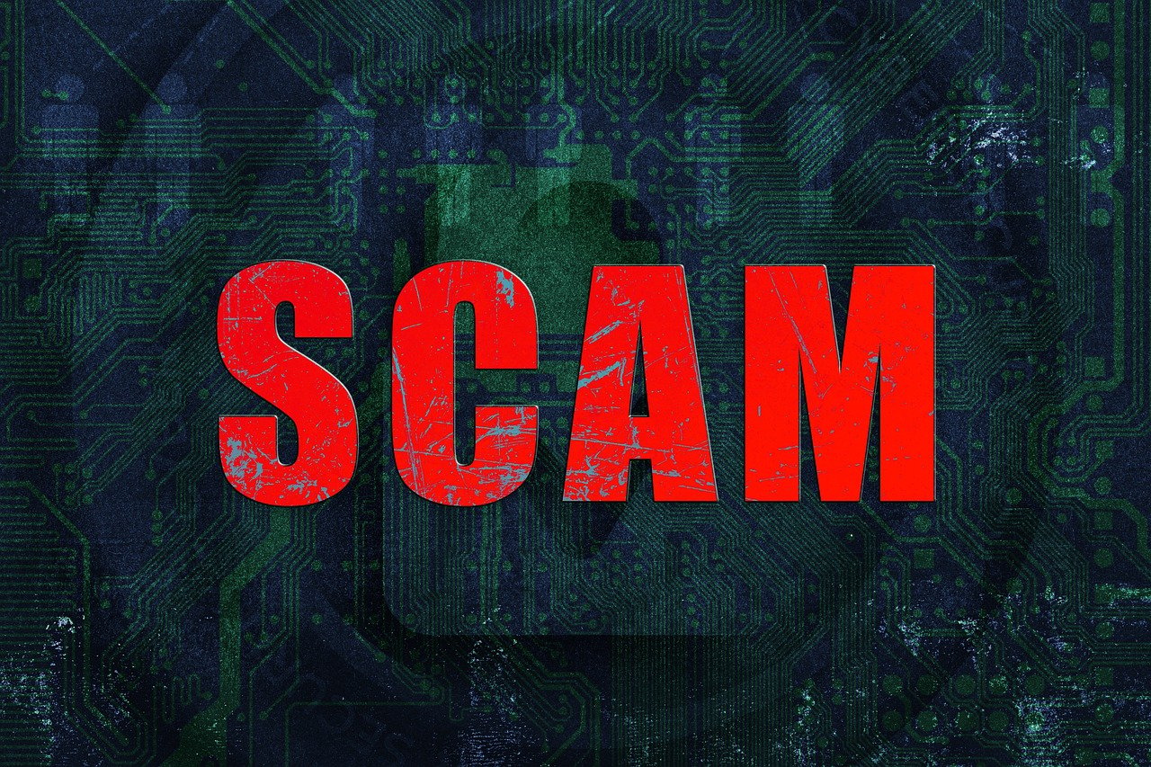 SCAM written in red letters