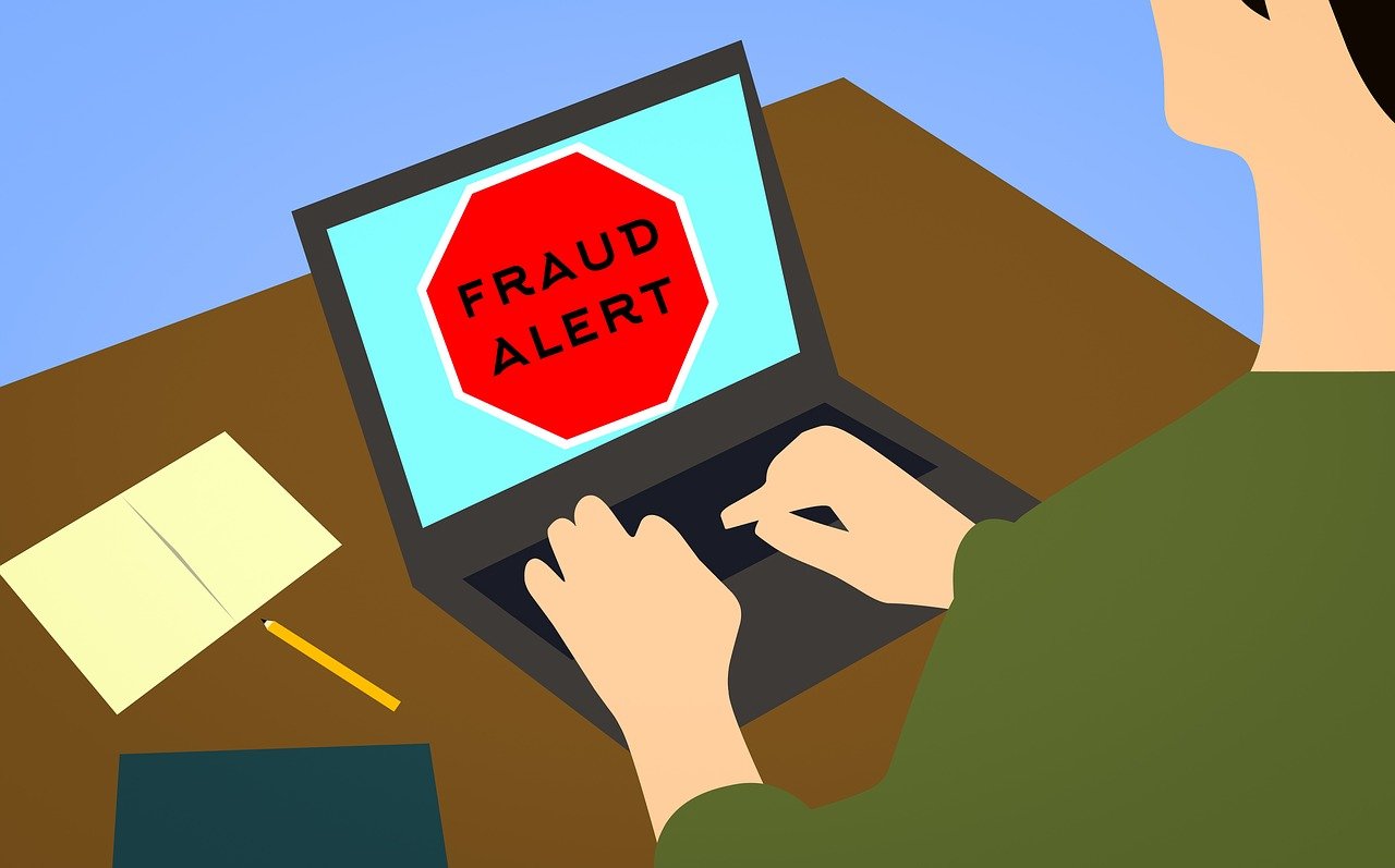 Fraud alert written on laptop screen