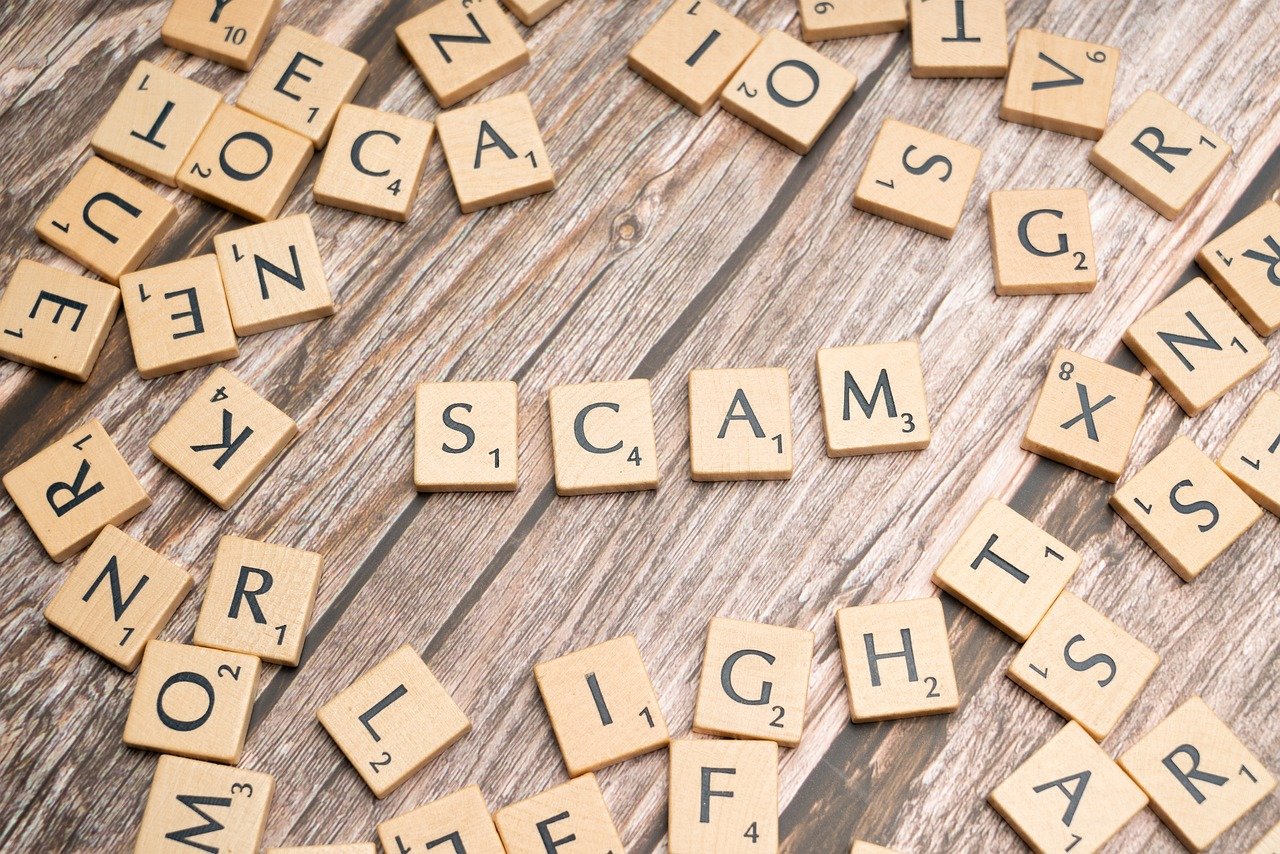Scam written in wooden tiles